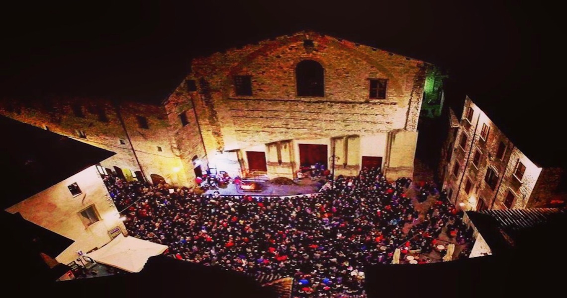 Piazza Giordano Bruno in Gubbio packed with people at the Feast of St Martin - Gubbio